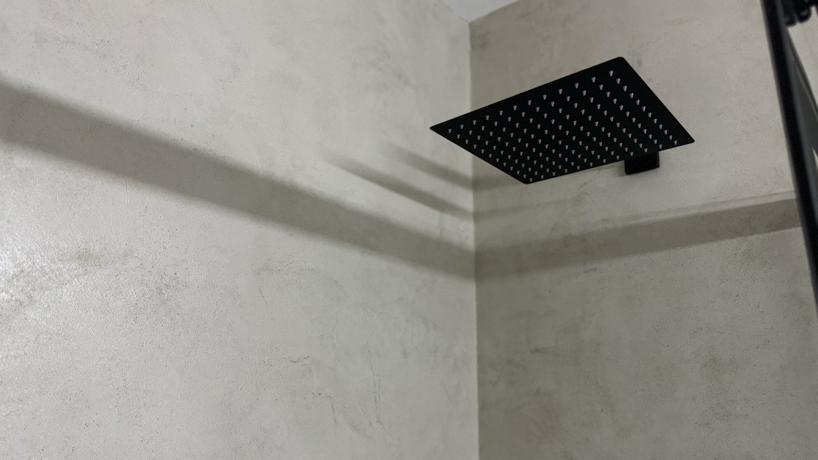 Microcement shower with modern rain head